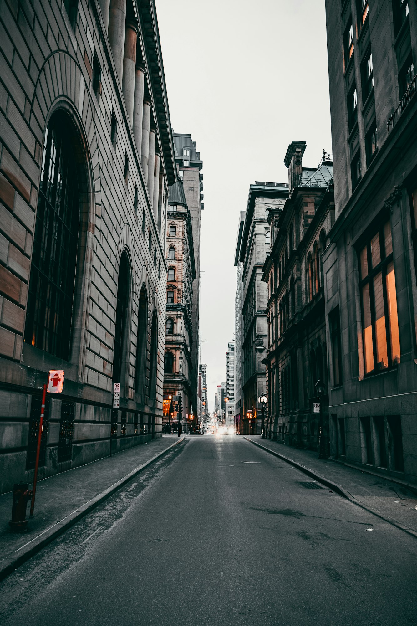 Vertical shot of an empty street between old buildings in Montreal, Ontario, Canada on a gloomy day